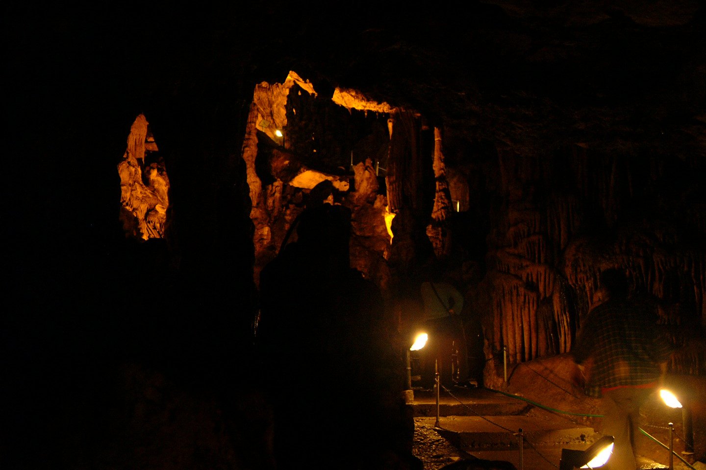 a group of people standing inside of a cave