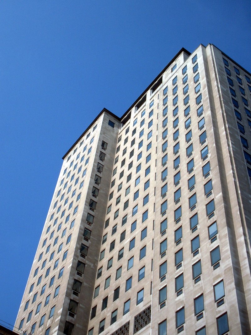 a very tall building sitting under a blue sky