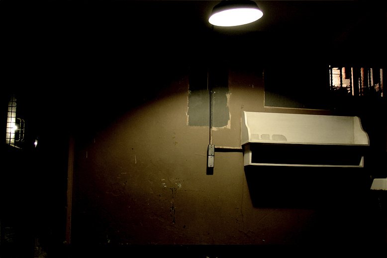 a toilet and some lights in a dark room