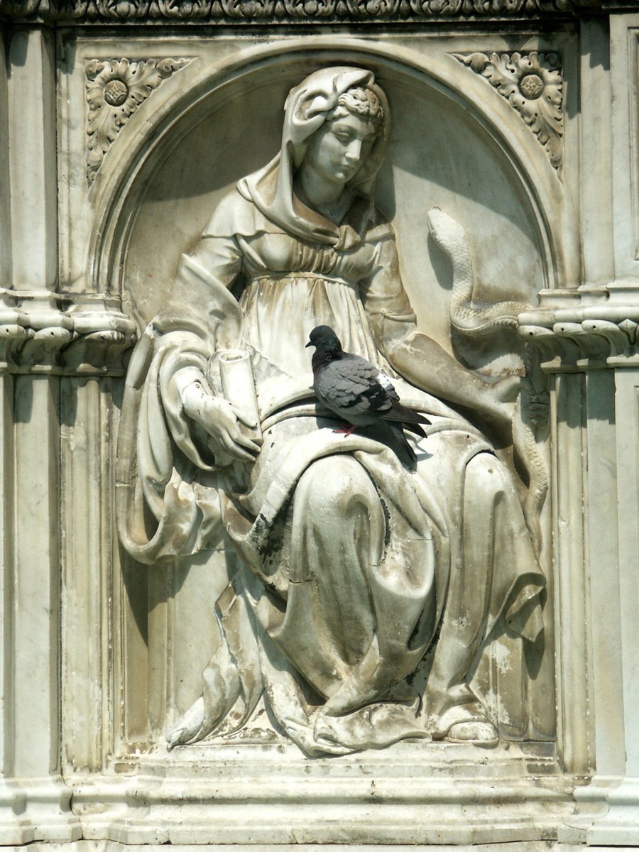 a statue with a raven sitting on the head of it