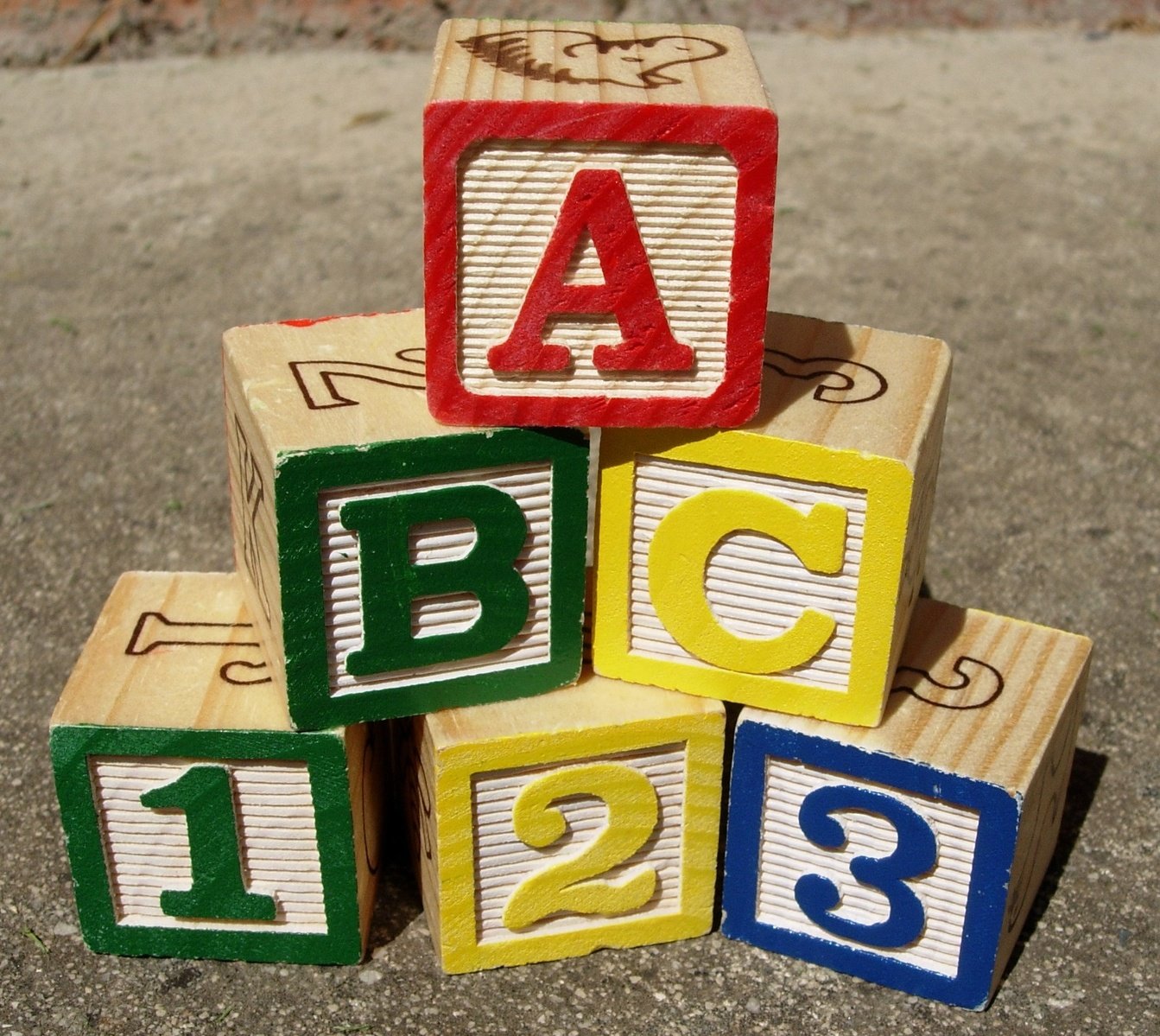 small wooden blocks shaped to form letters in a pyramid