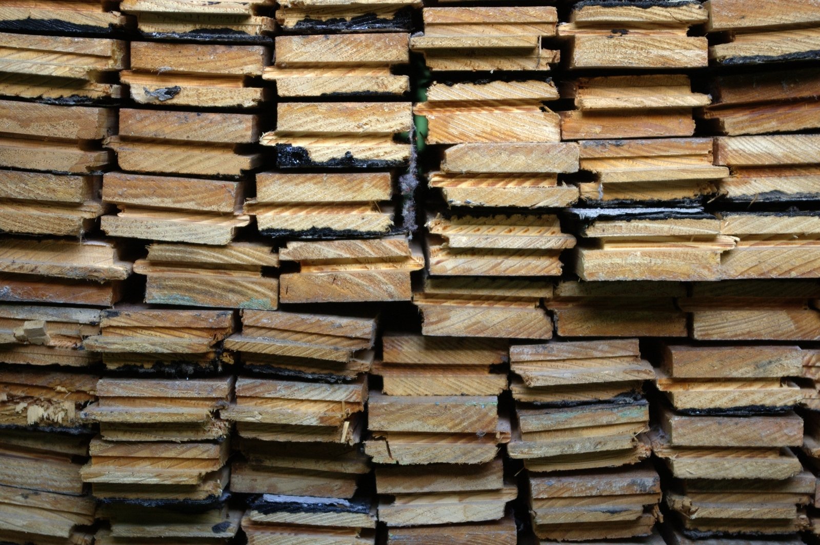 a large pile of wood is piled up