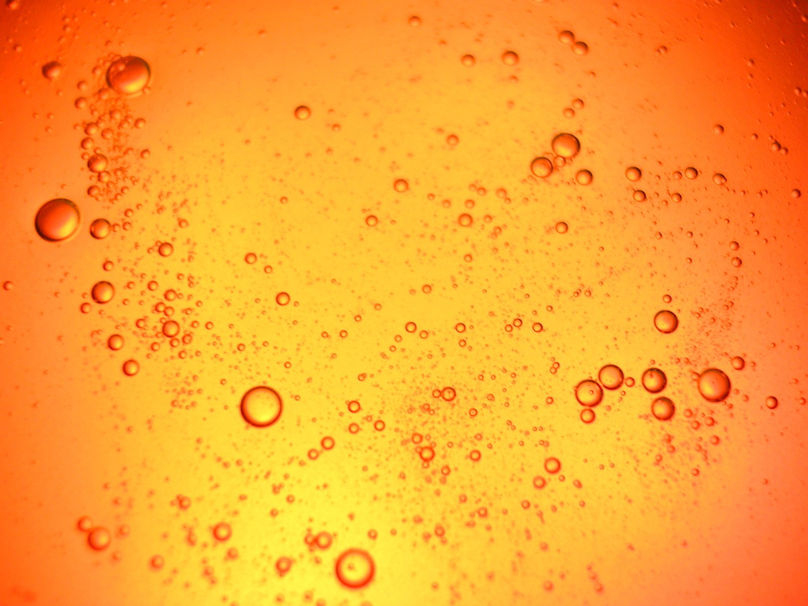 water bubbles that are orange and yellow in the middle of a body of water
