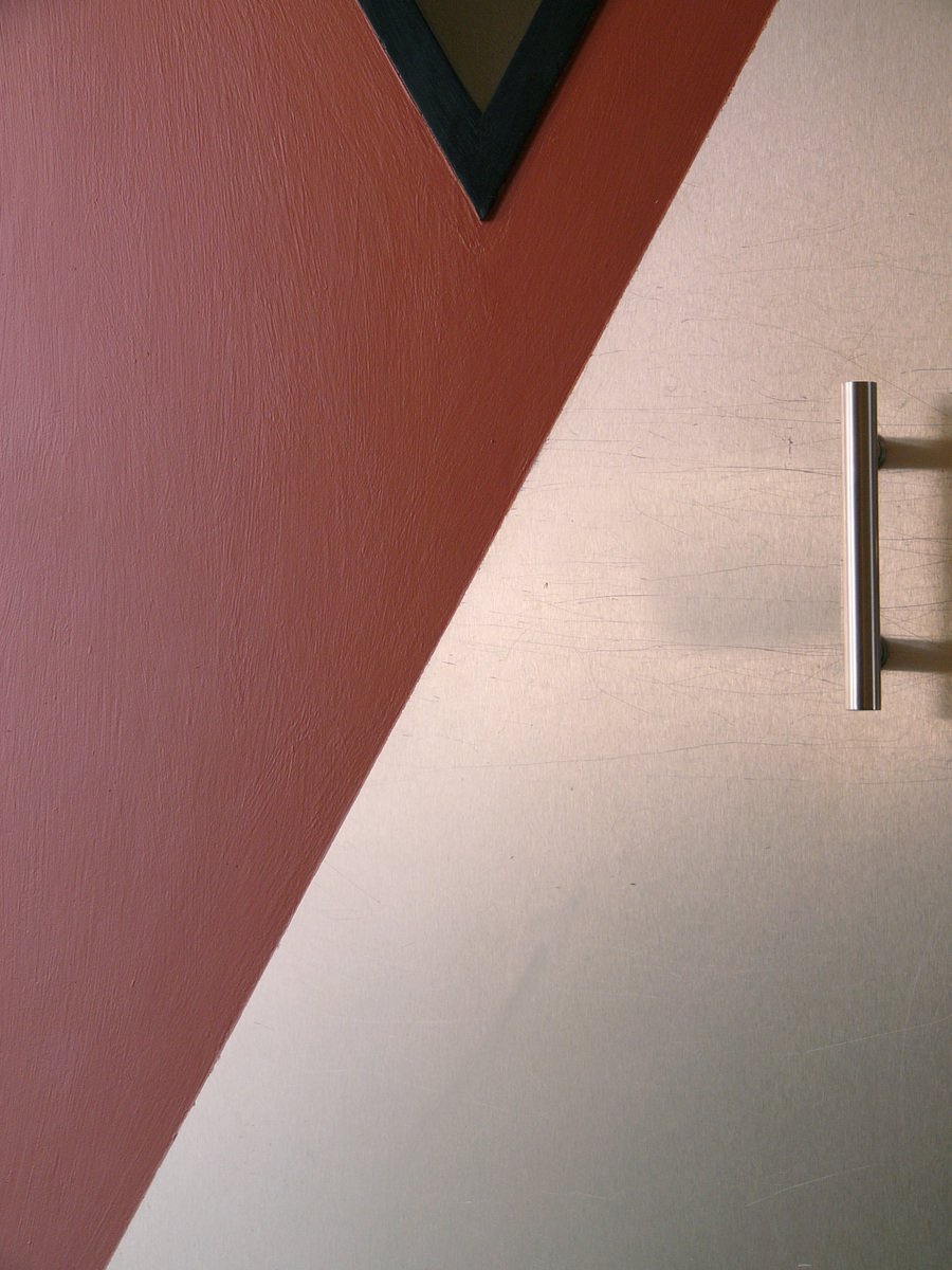 an arrow shaped object is shown on a wall
