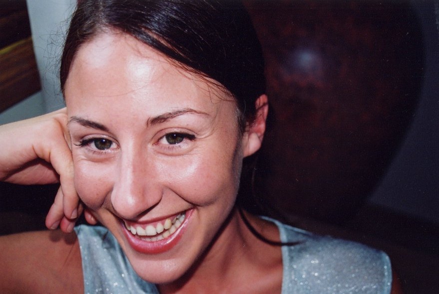 a girl smiles as she poses for the camera