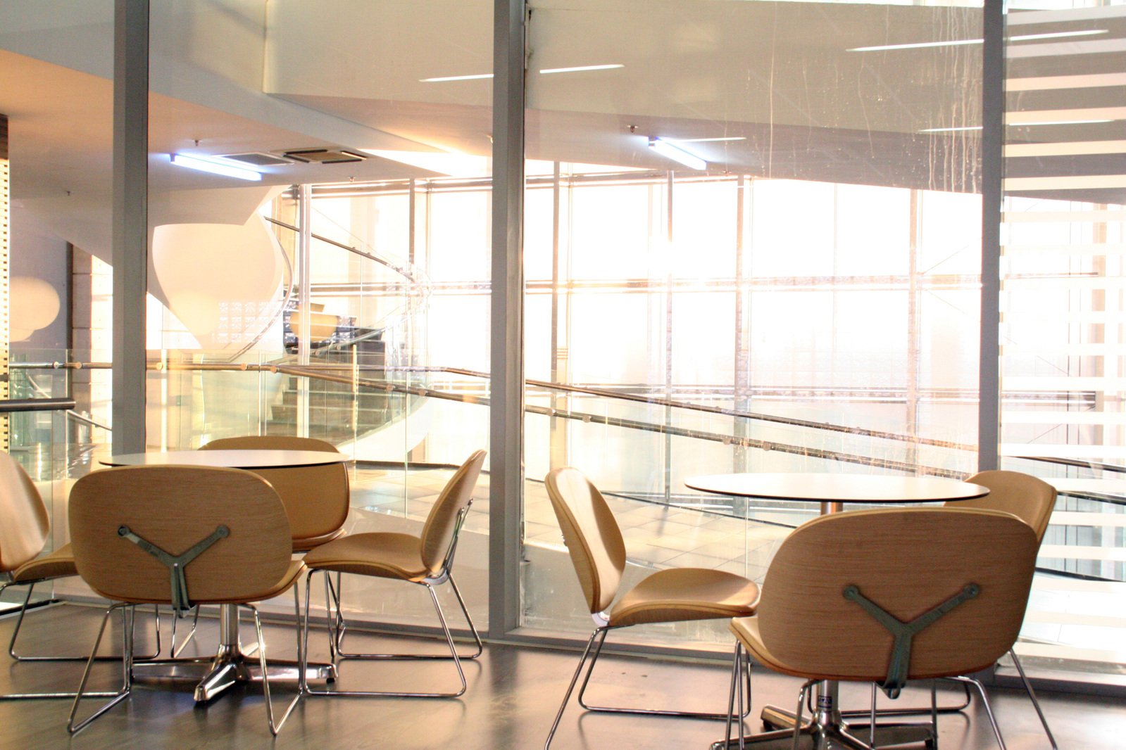 a glass walled area with a conference table and chairs