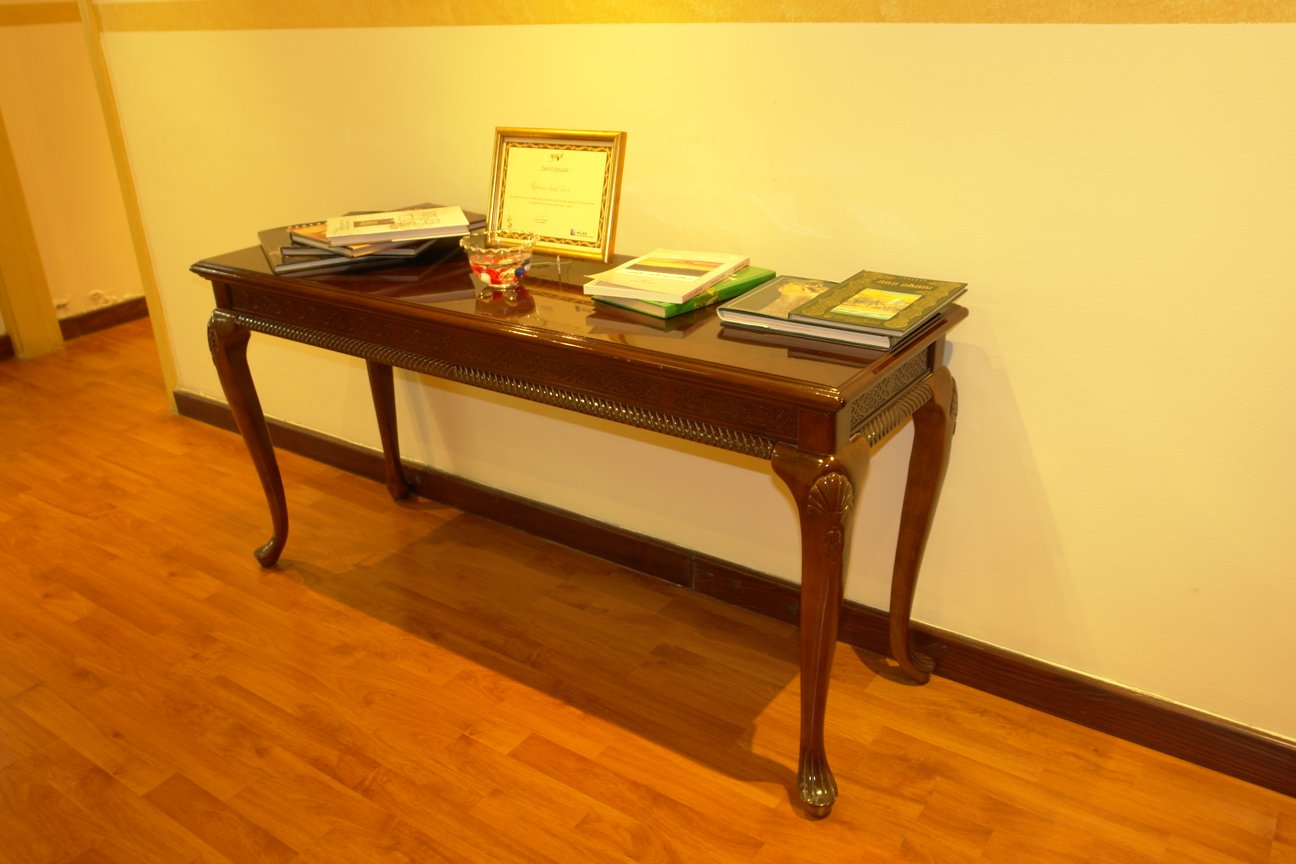 a wooden table topped with books and a plaque