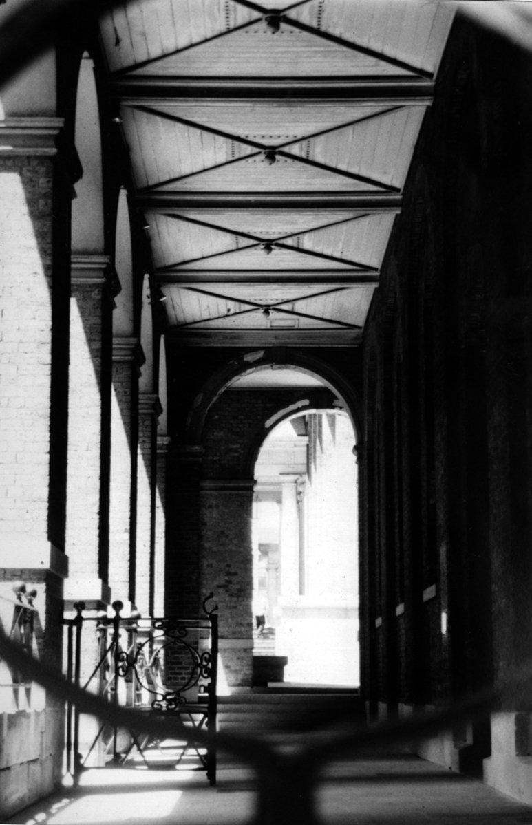black and white pograph of a building with a canopy over the walkway