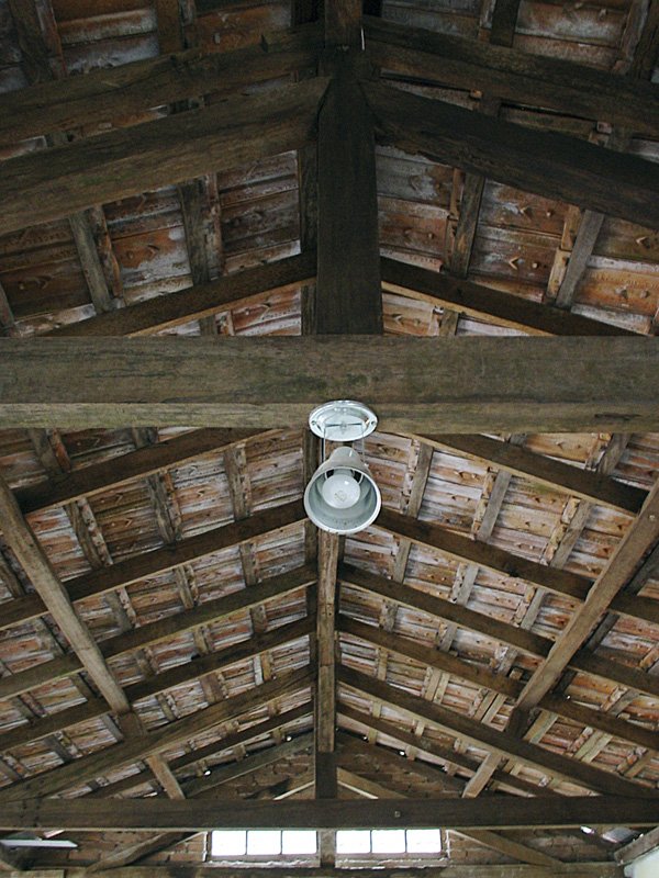 an empty building with wooden ceilinging and beams