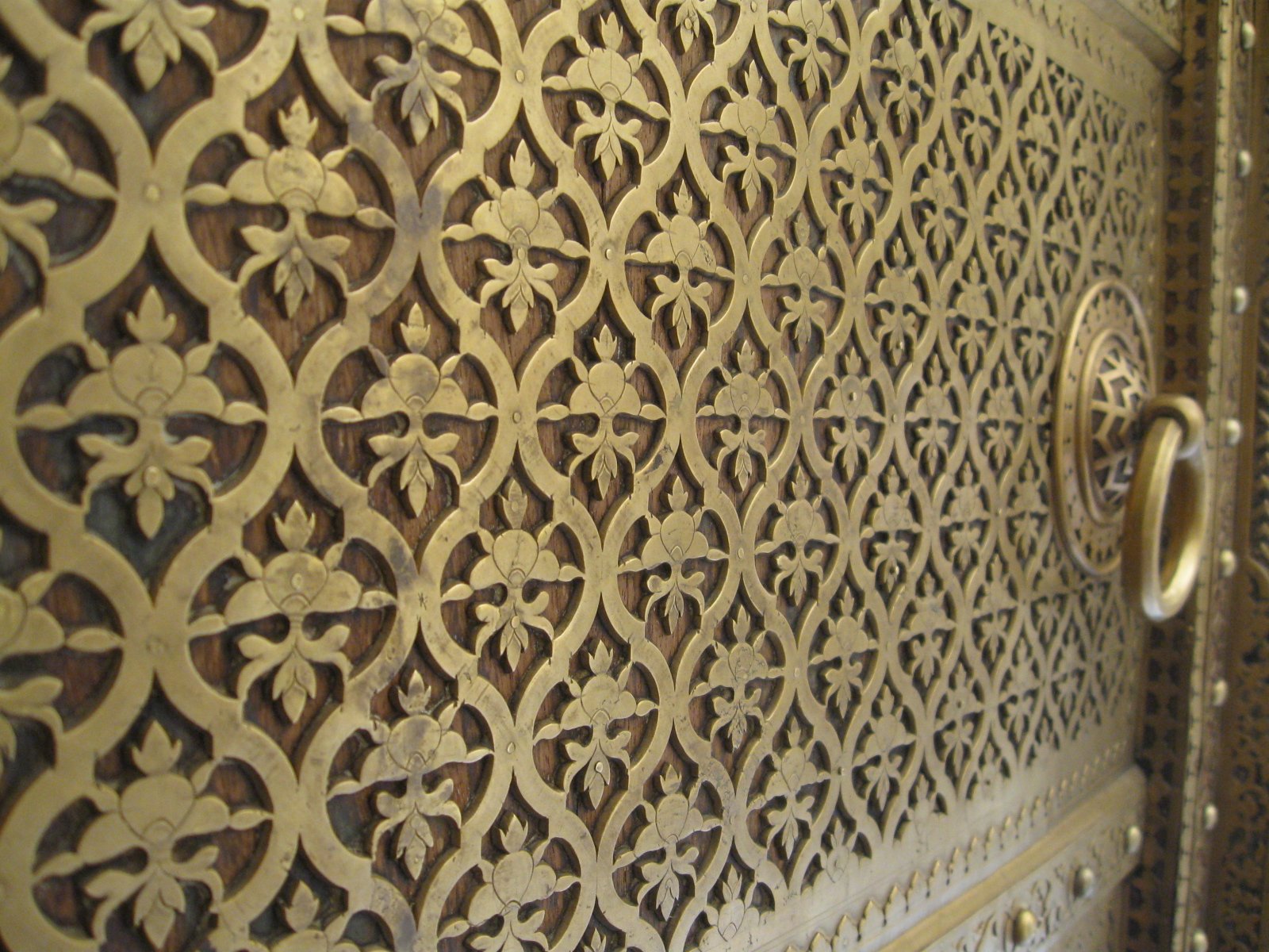 a gold door has intricately cutouts on it