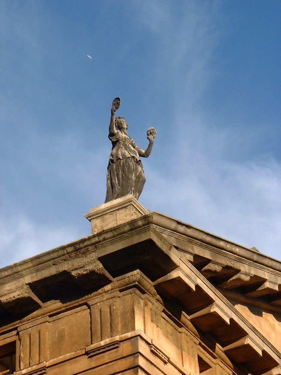 a statue on top of a building in the daytime