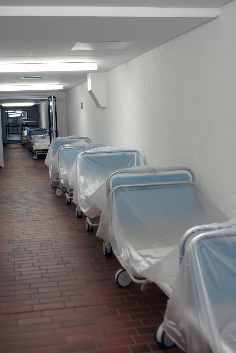 this is a long row of hospital beds in a hallway