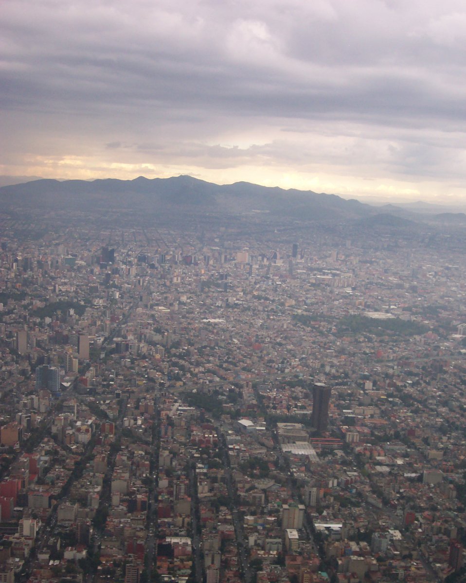 view of city and mountains from high above