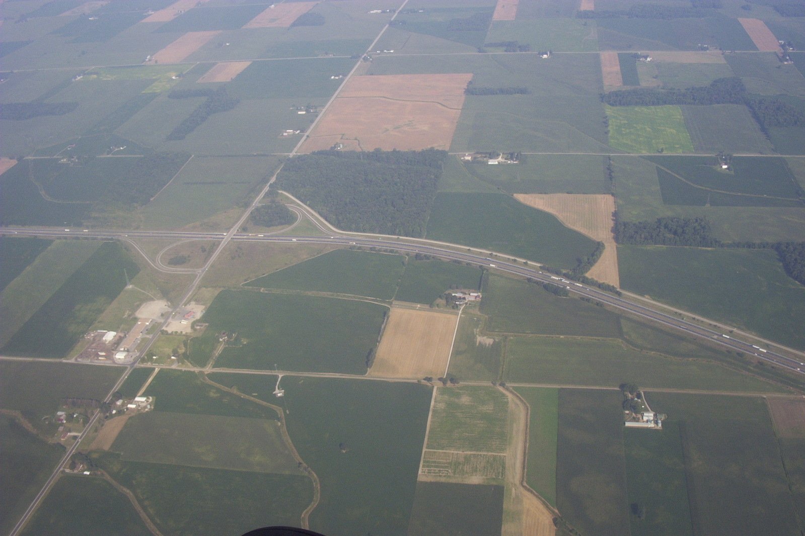 an aerial po looking down on the highway and fields