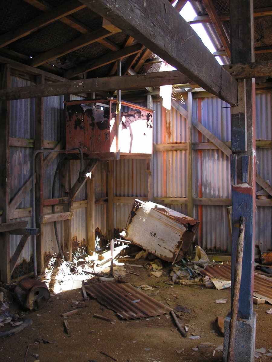 a run down building with the roof broken off