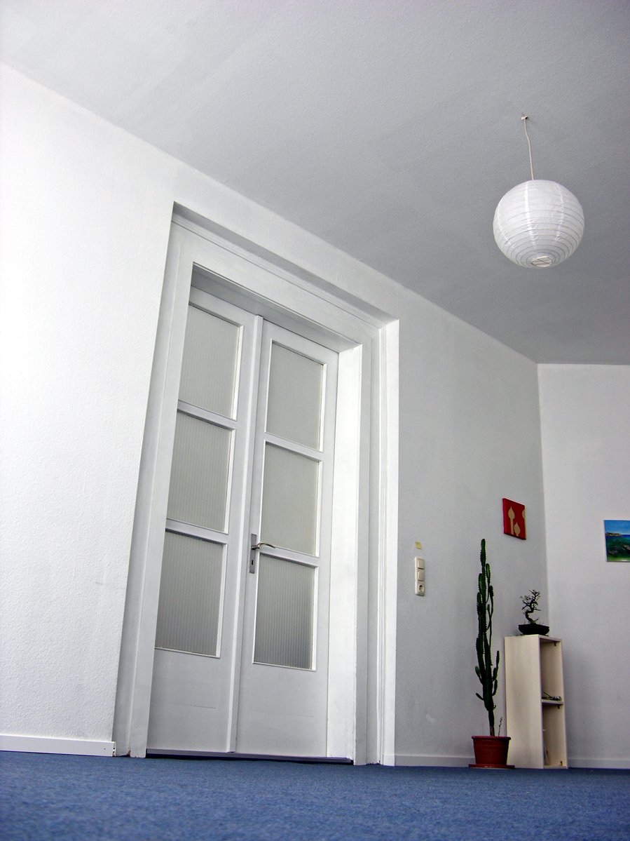 white interior with a door and a large light