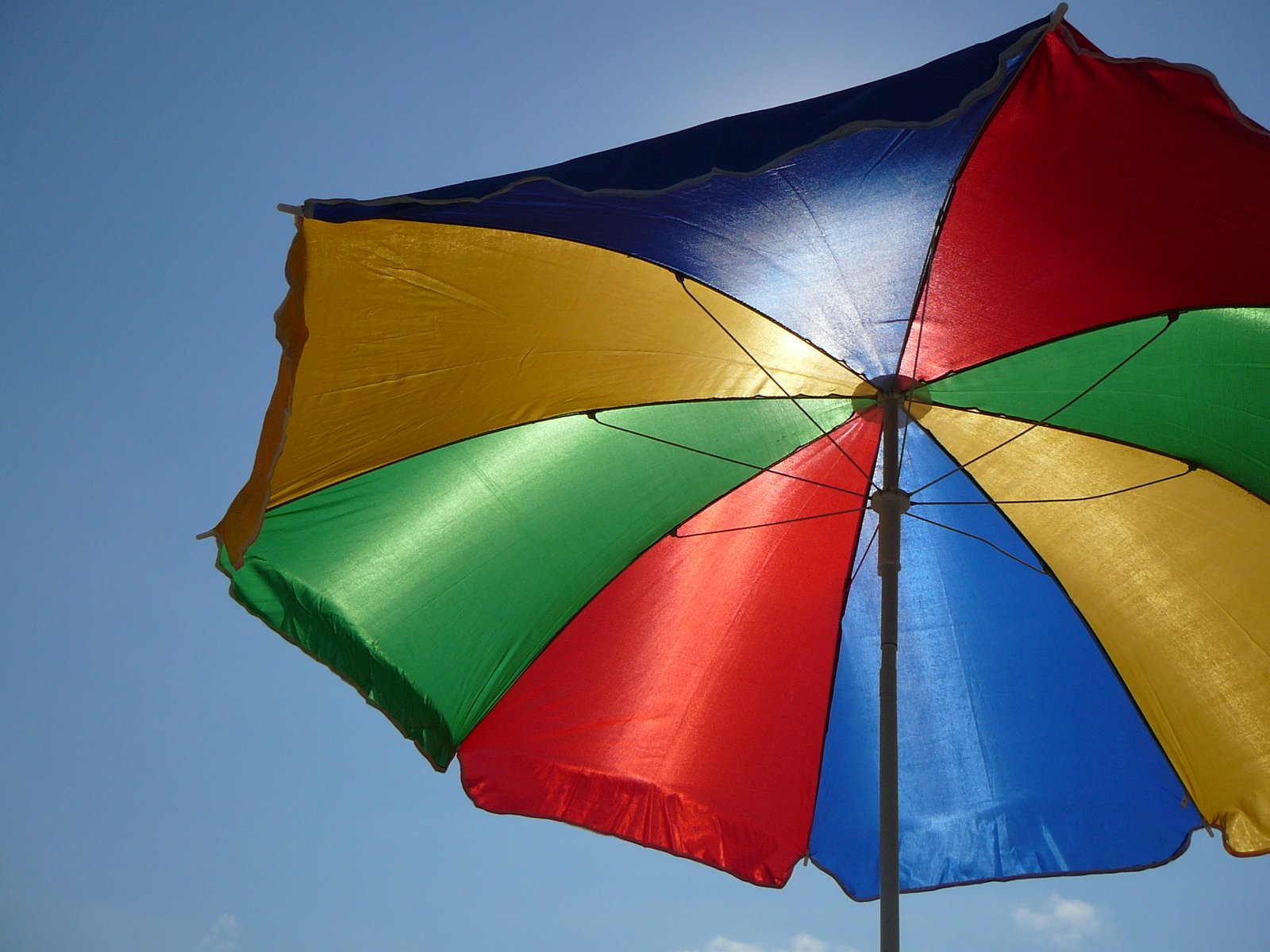 an upside down umbrella is hanging from a pole