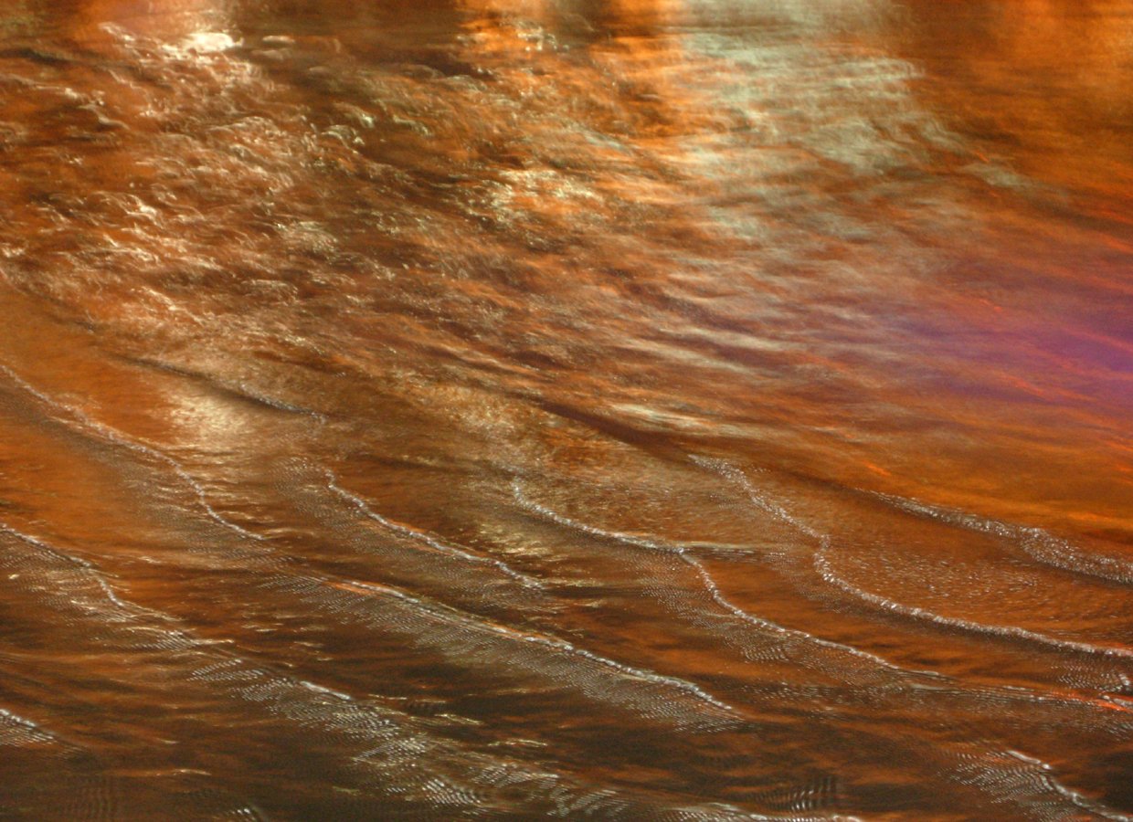 an orange and pink po of water with waves