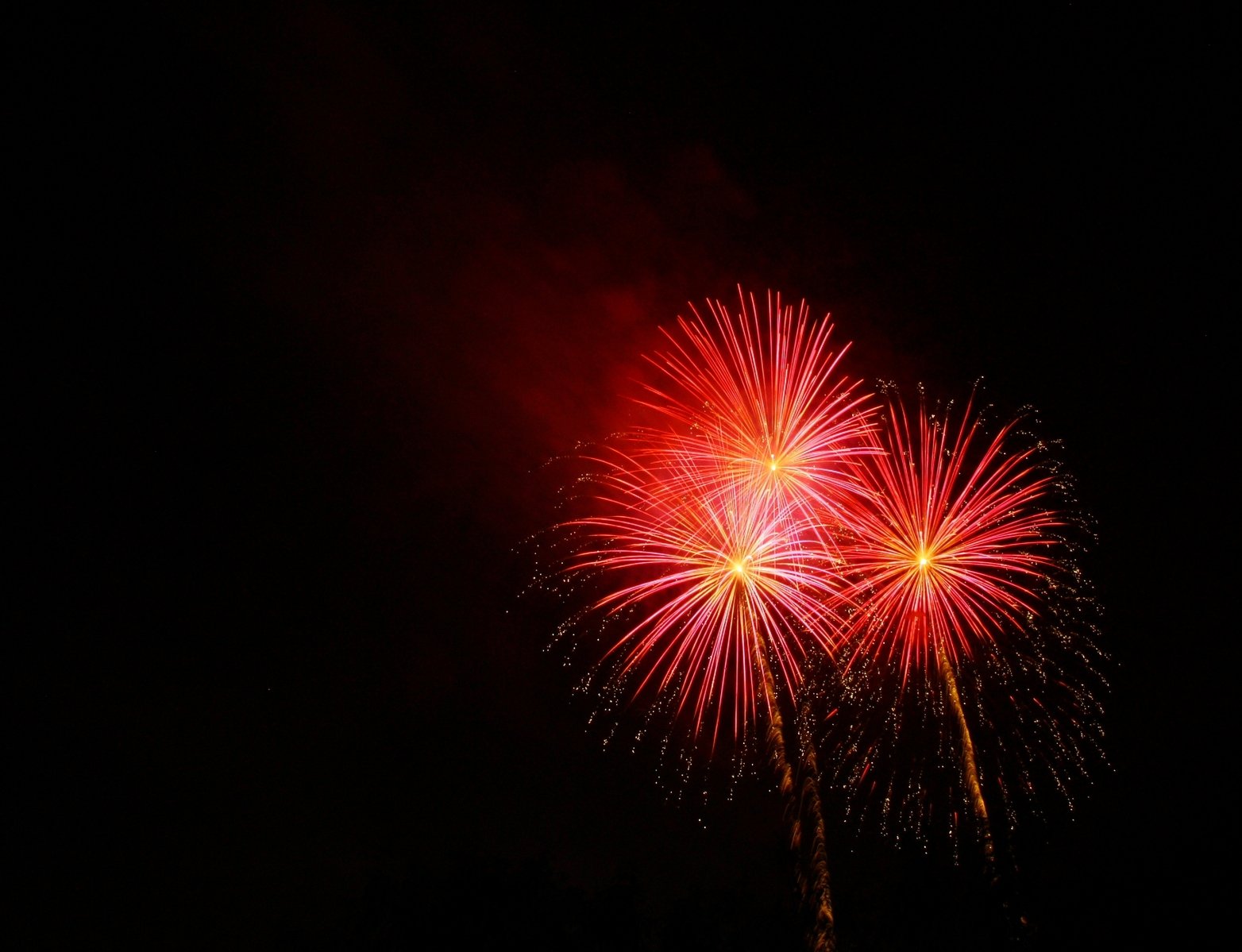 fireworks at night time with red and white lights