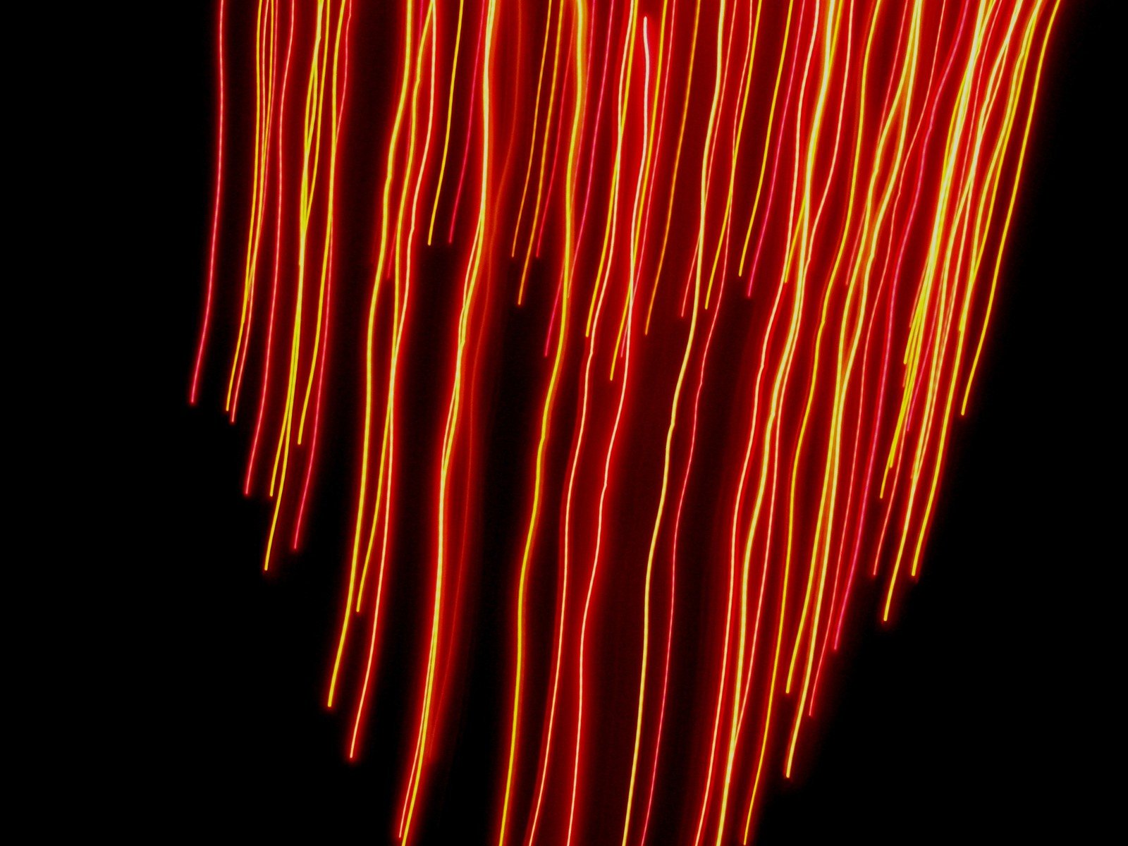 a bright red and yellow light in a black background