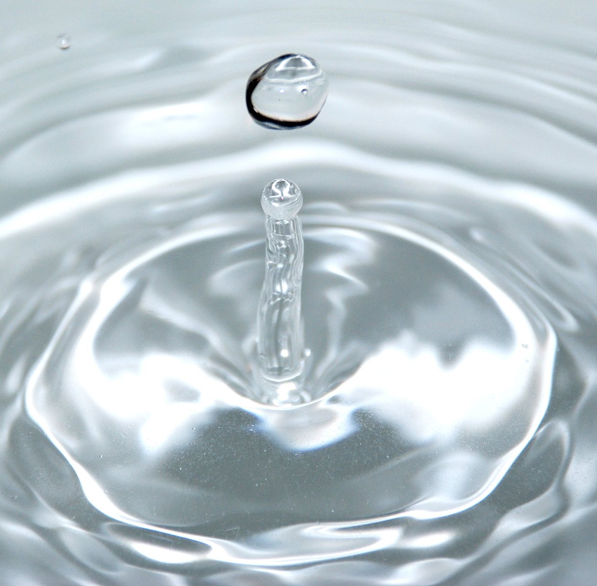 a white water ripple with small circular shape in it