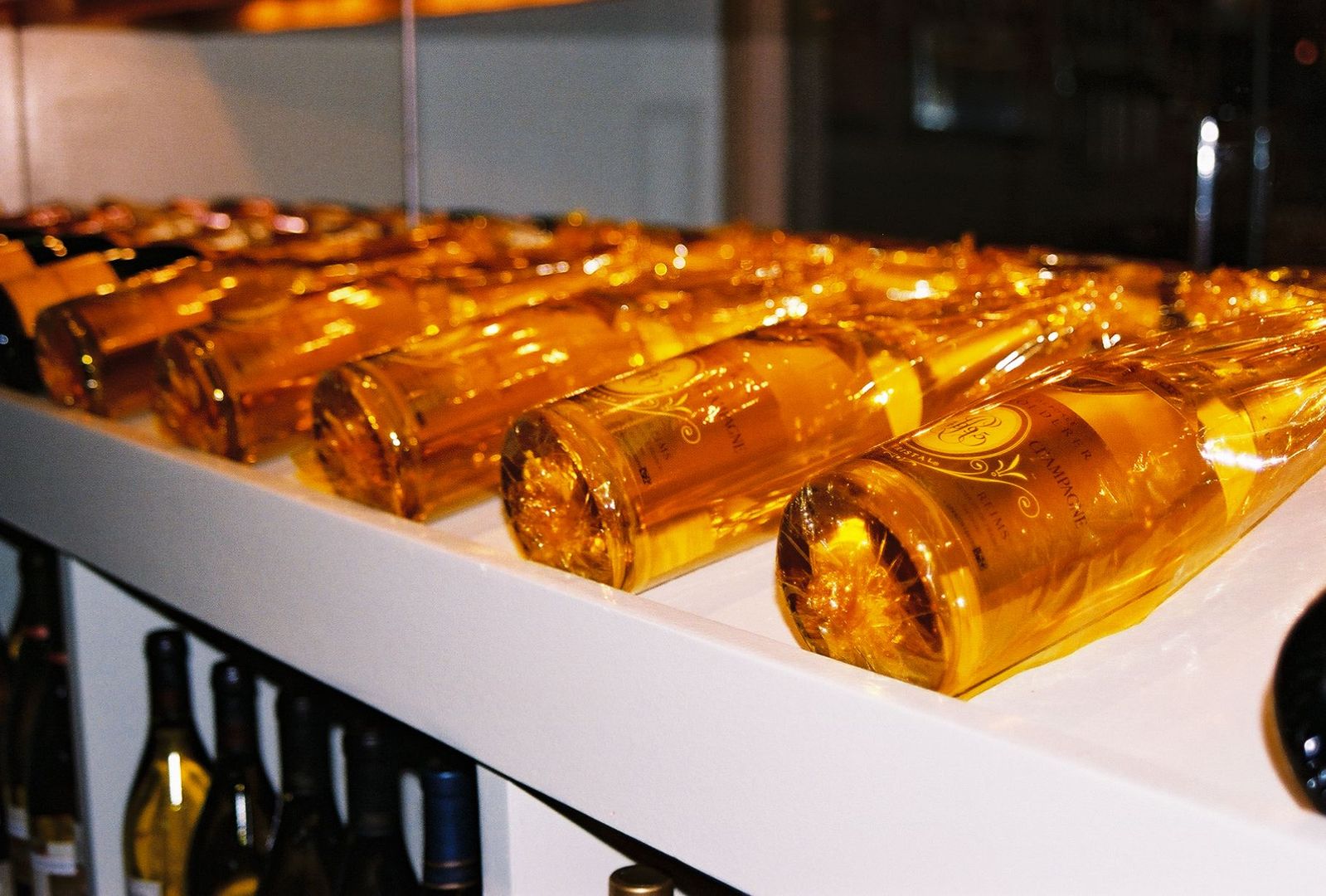 a row of gold cylindrical bottles on display