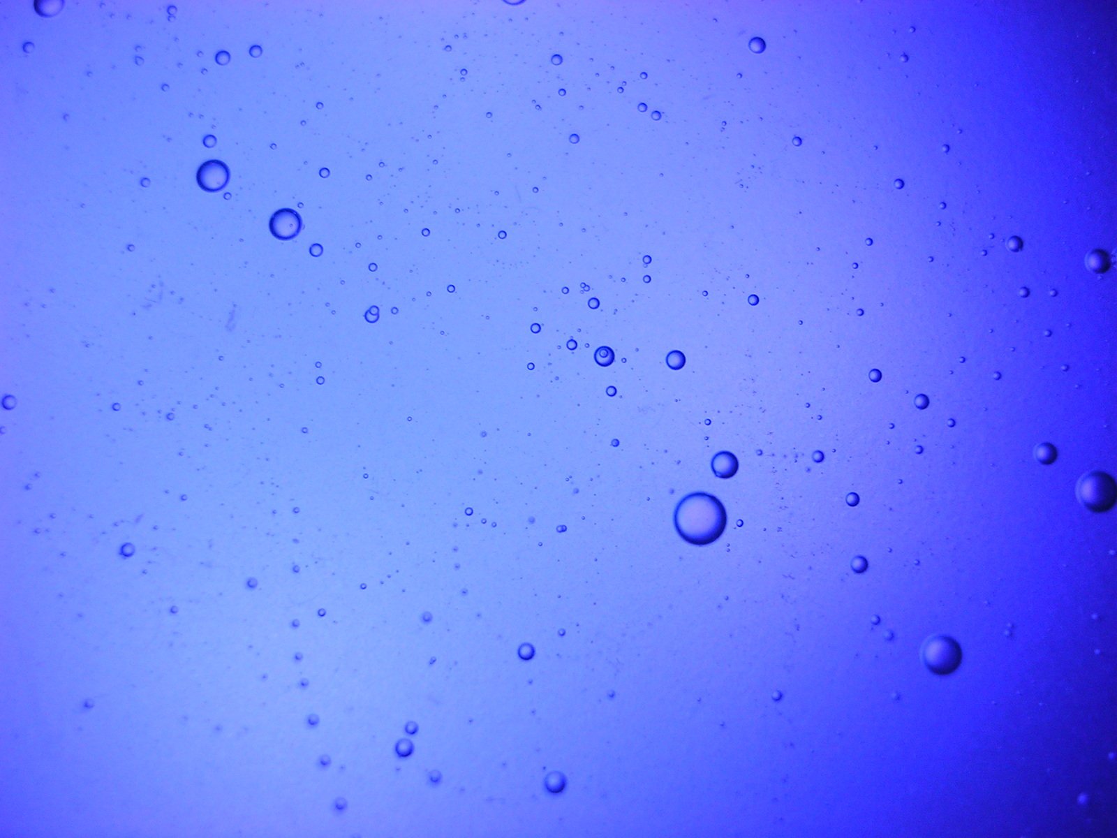 some water that is blue and has drops of water