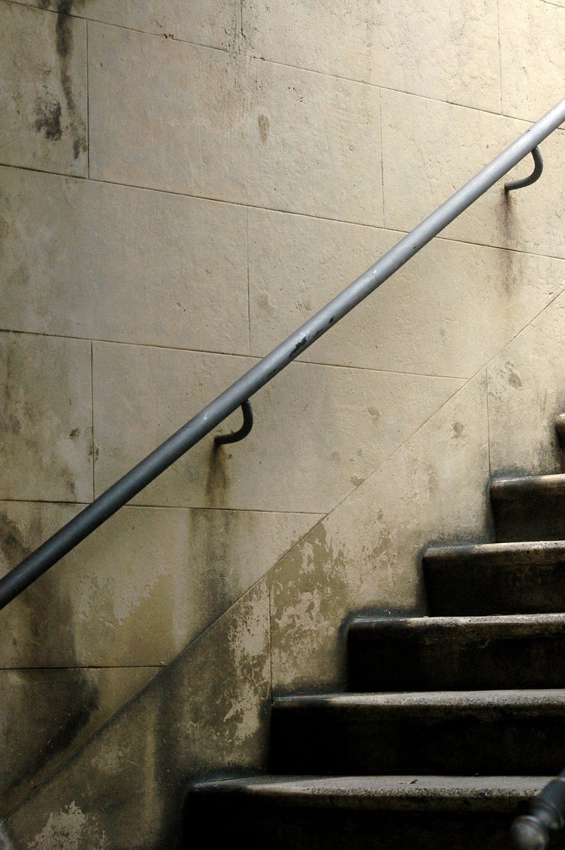 a person climbing some steps holding a skateboard