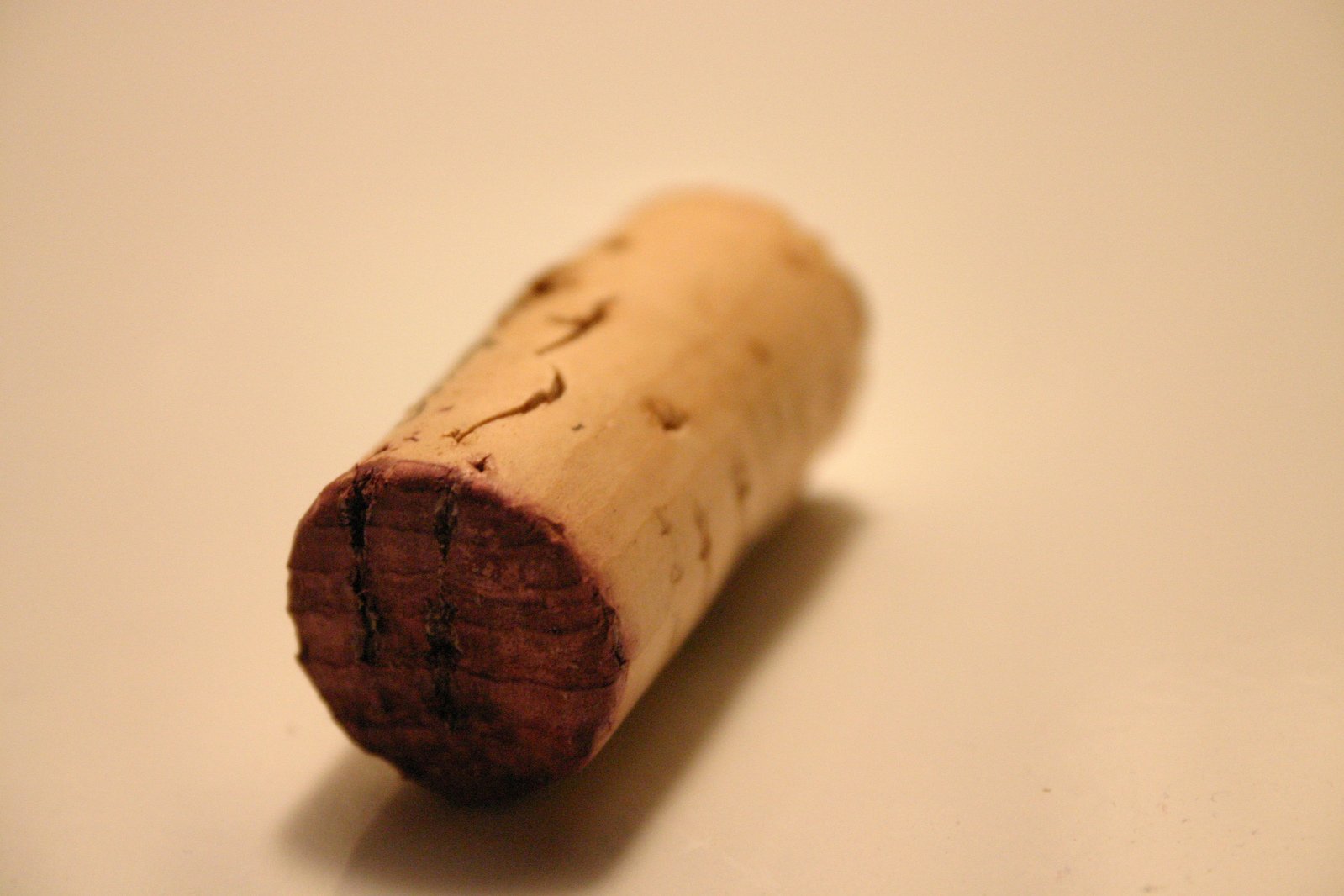 a close up of a wine cork on a white table