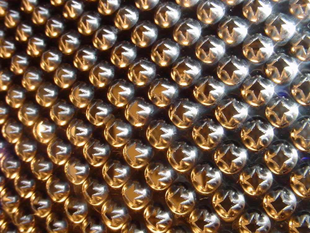 a metal surface with golden circles