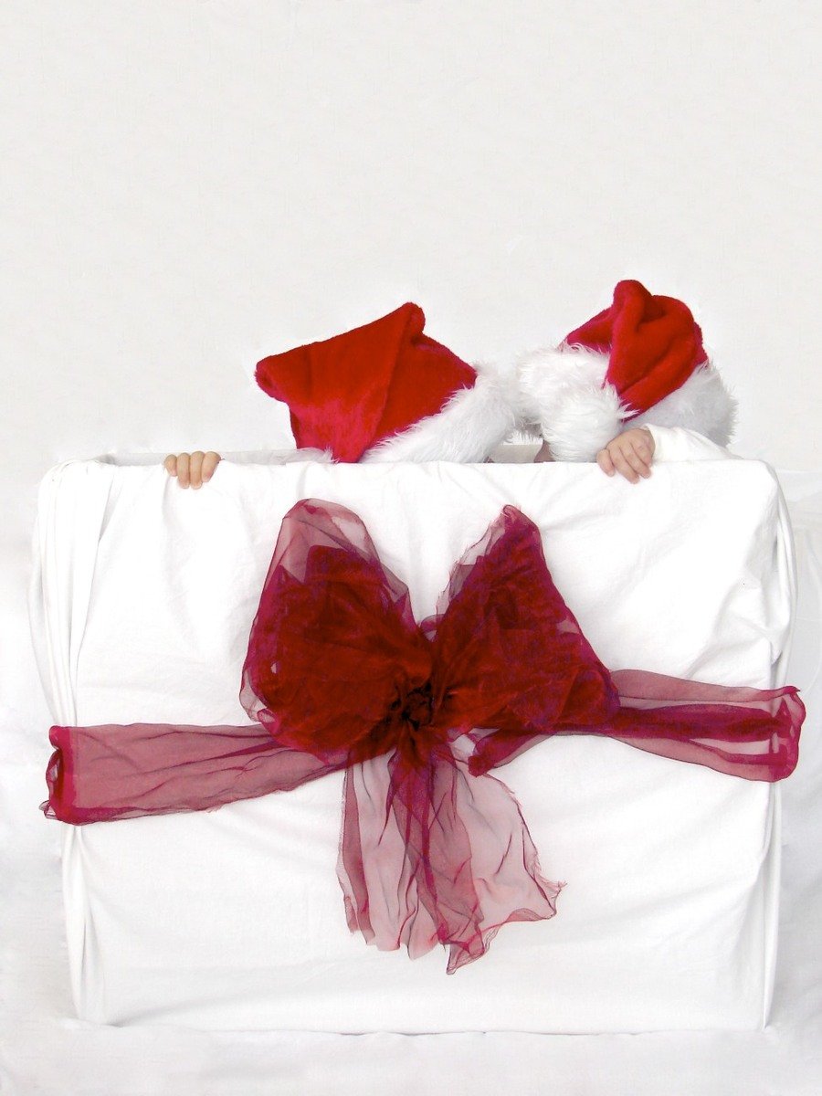 the baby in santa's suit is in a big box