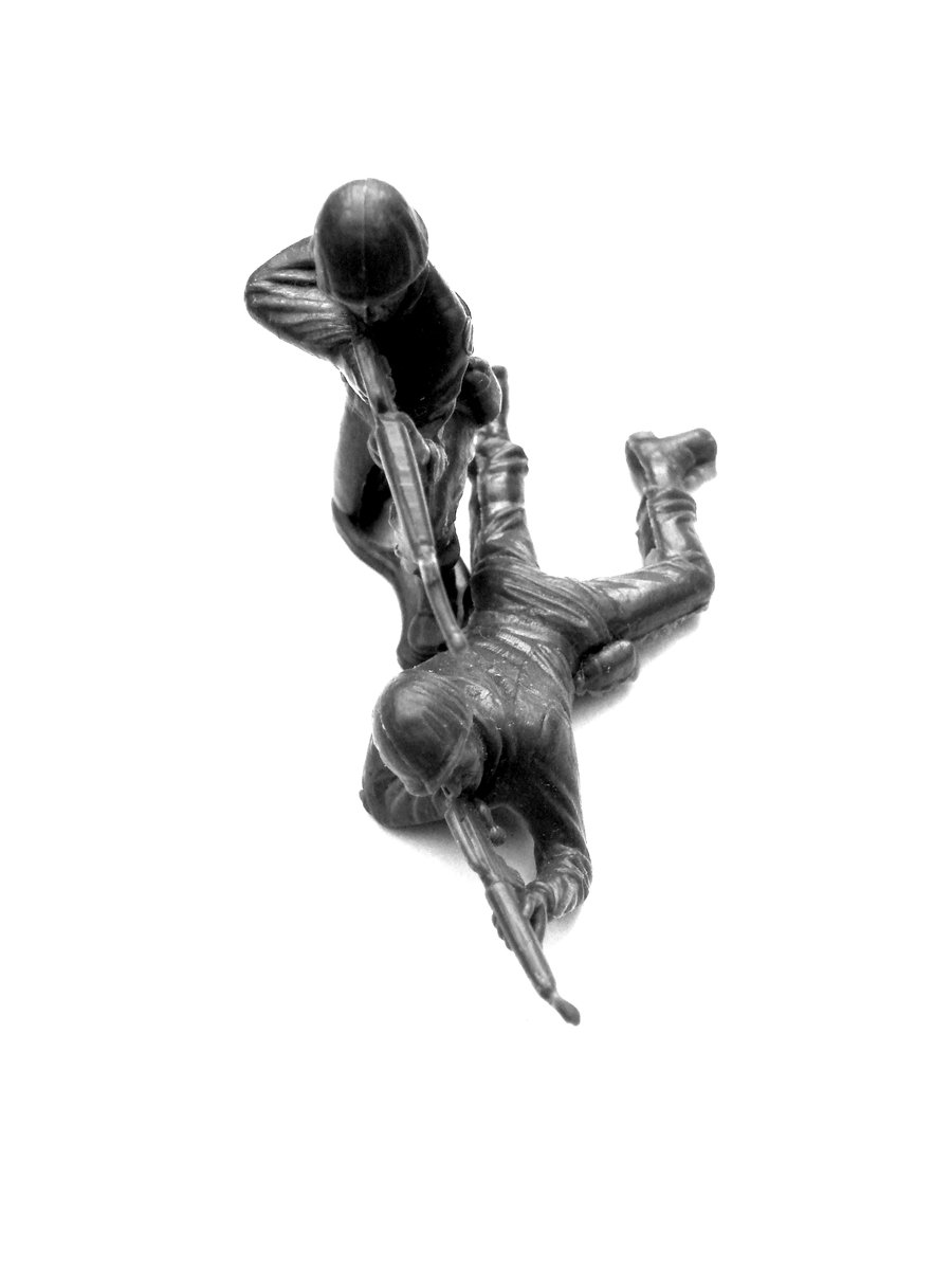 a sculpture of a man in a suit and hat is flying