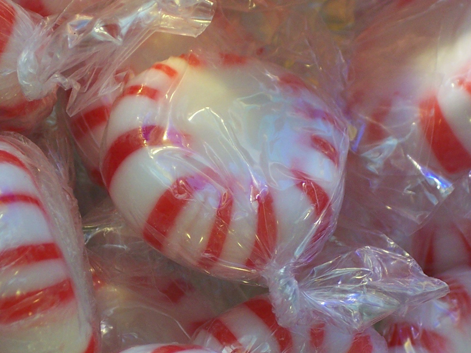 several red and white lollipops wrapped in plastic