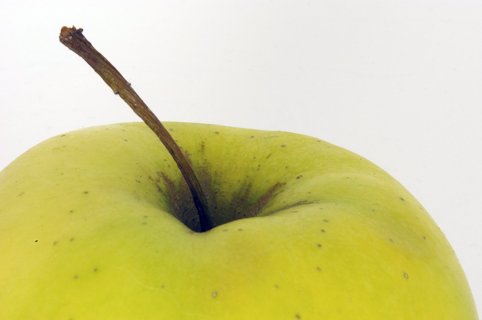 an apple with brown seeds is sitting on a table