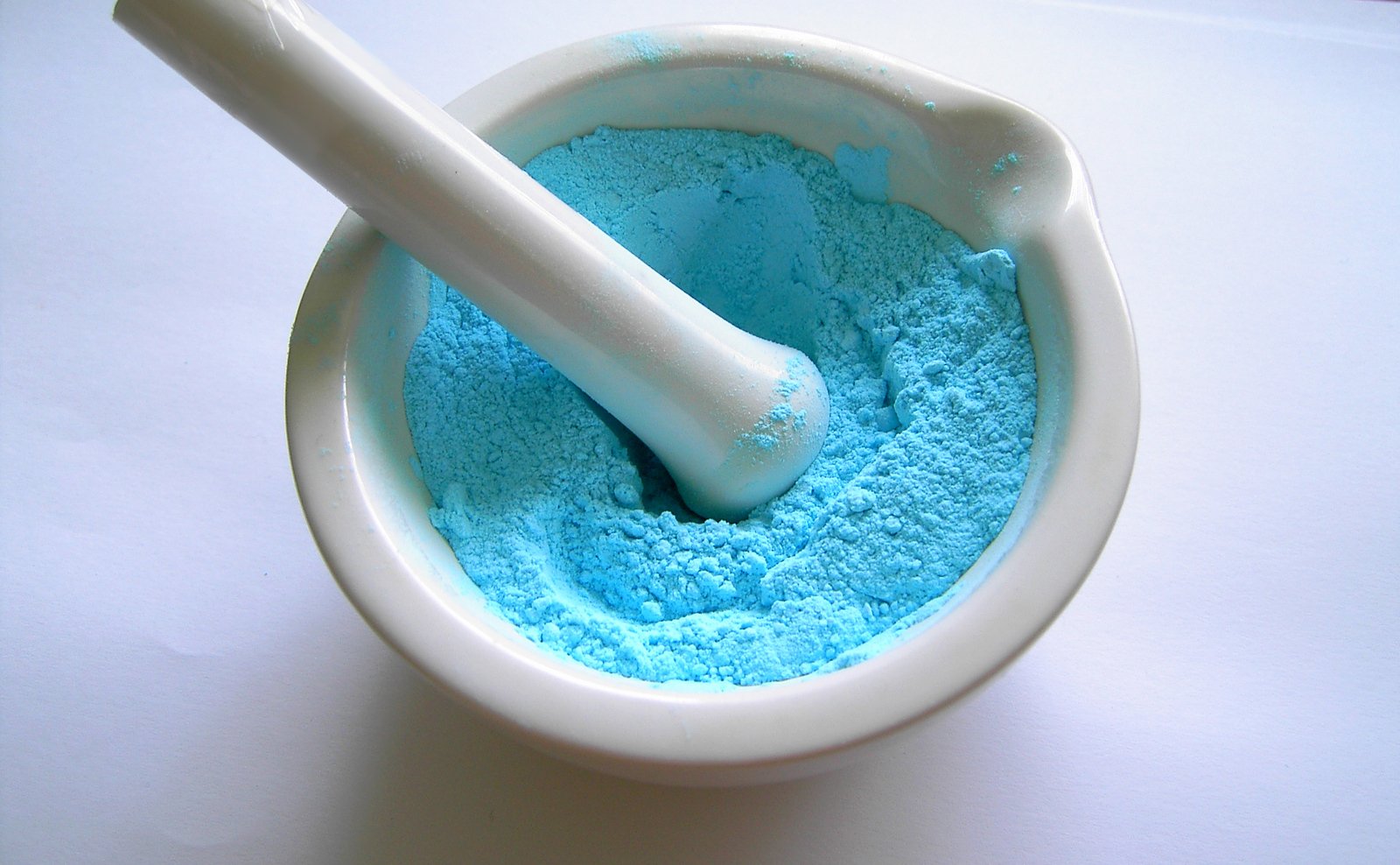 a white mortar and pestle in a bowl