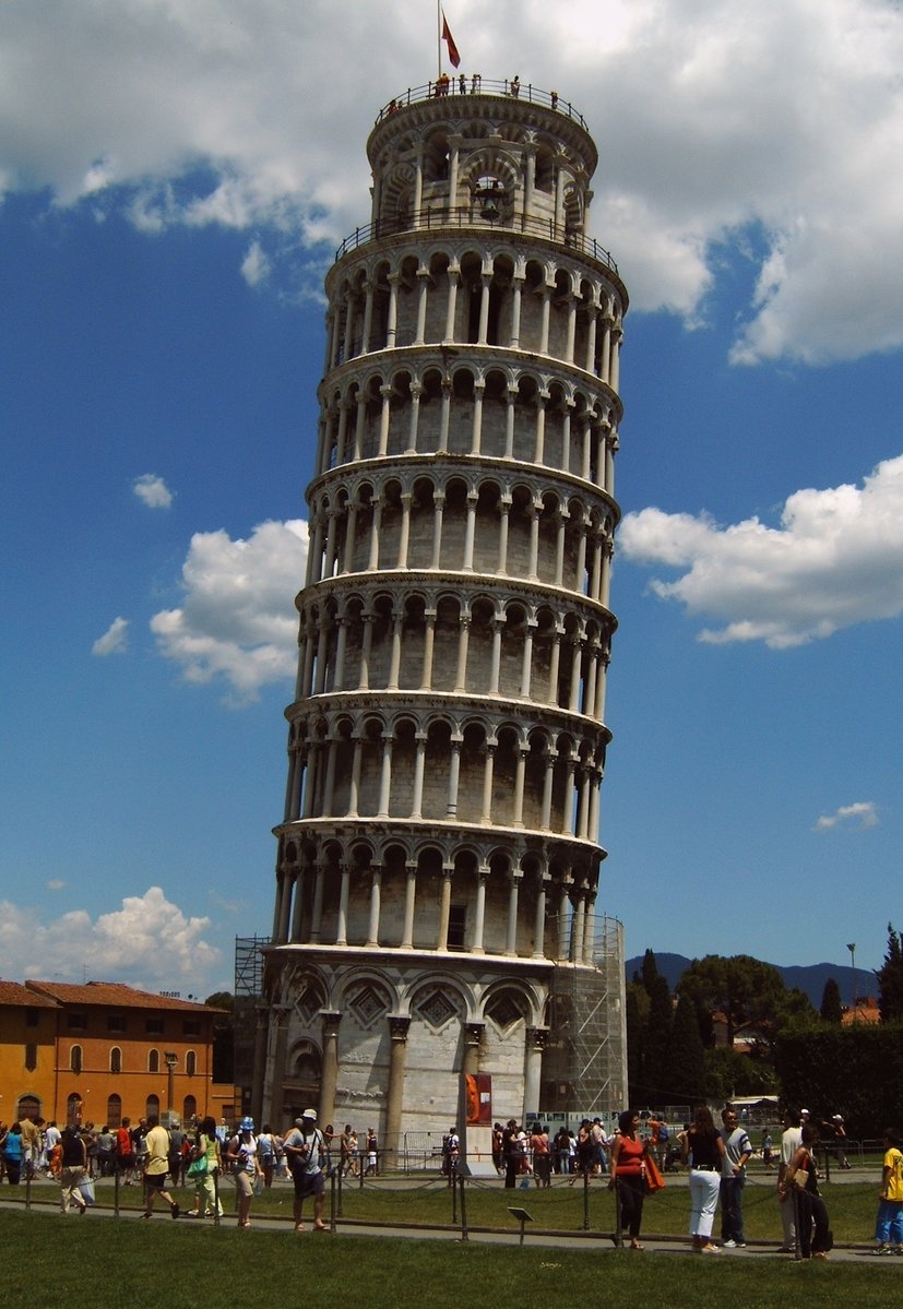 a large gray leaning tower with people around