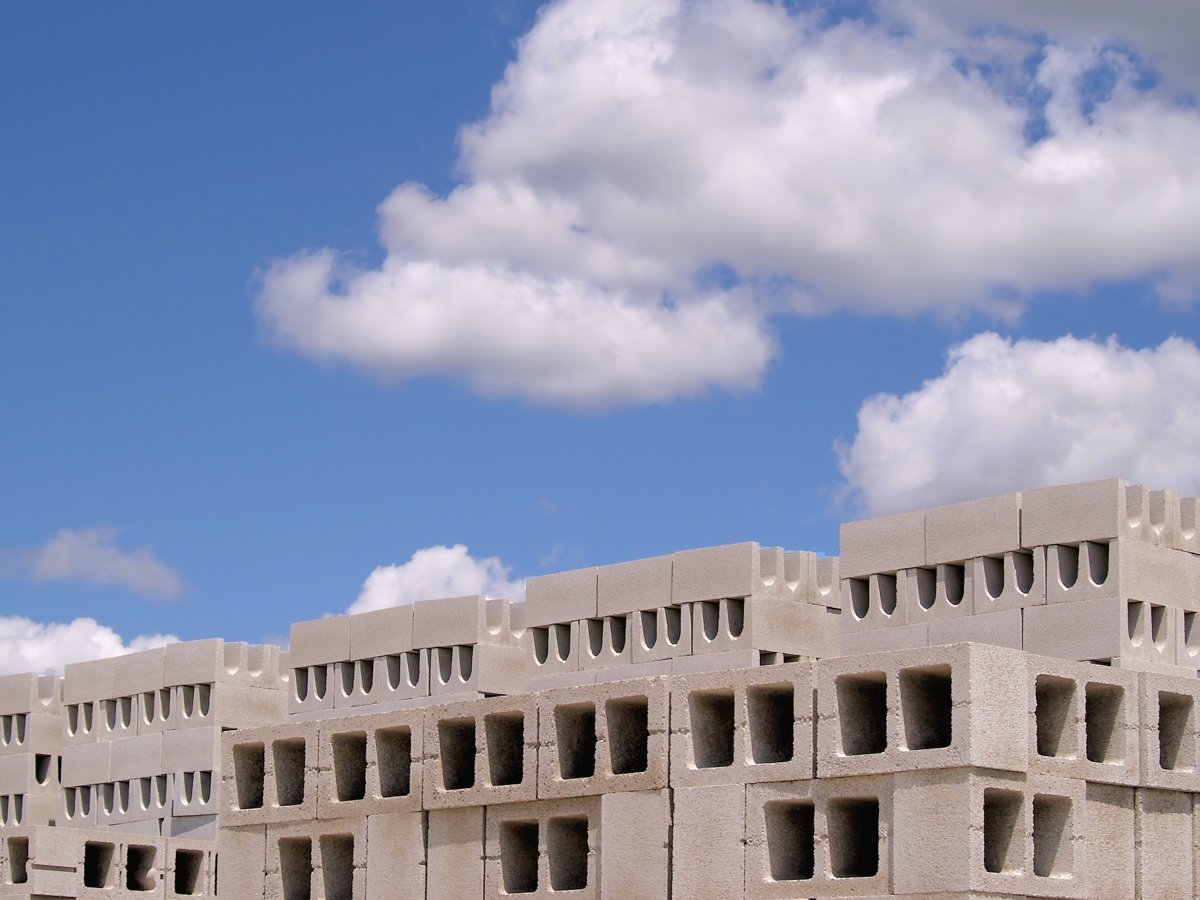 a very old concrete building is shown under some clouds