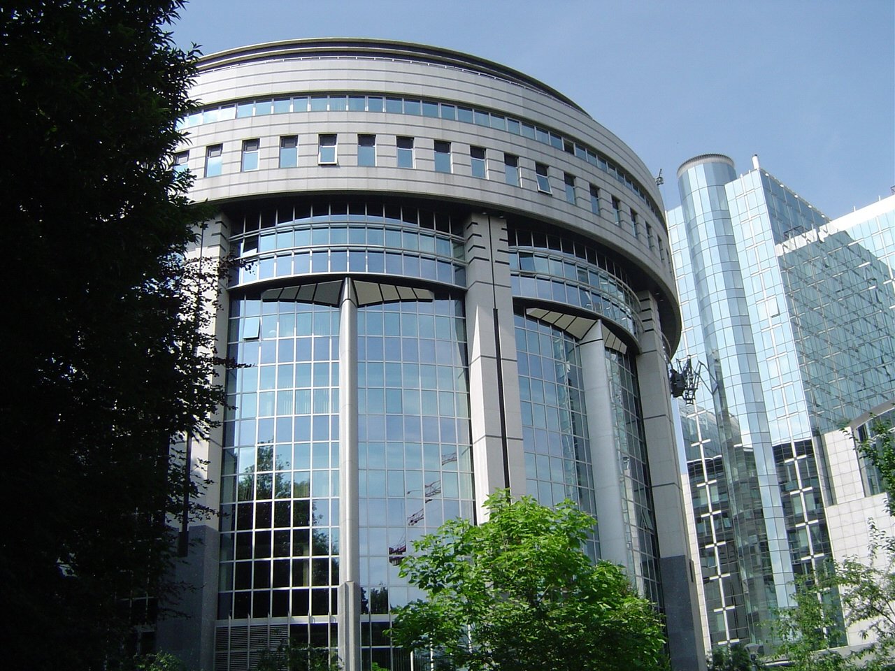 large office building surrounded by tall buildings