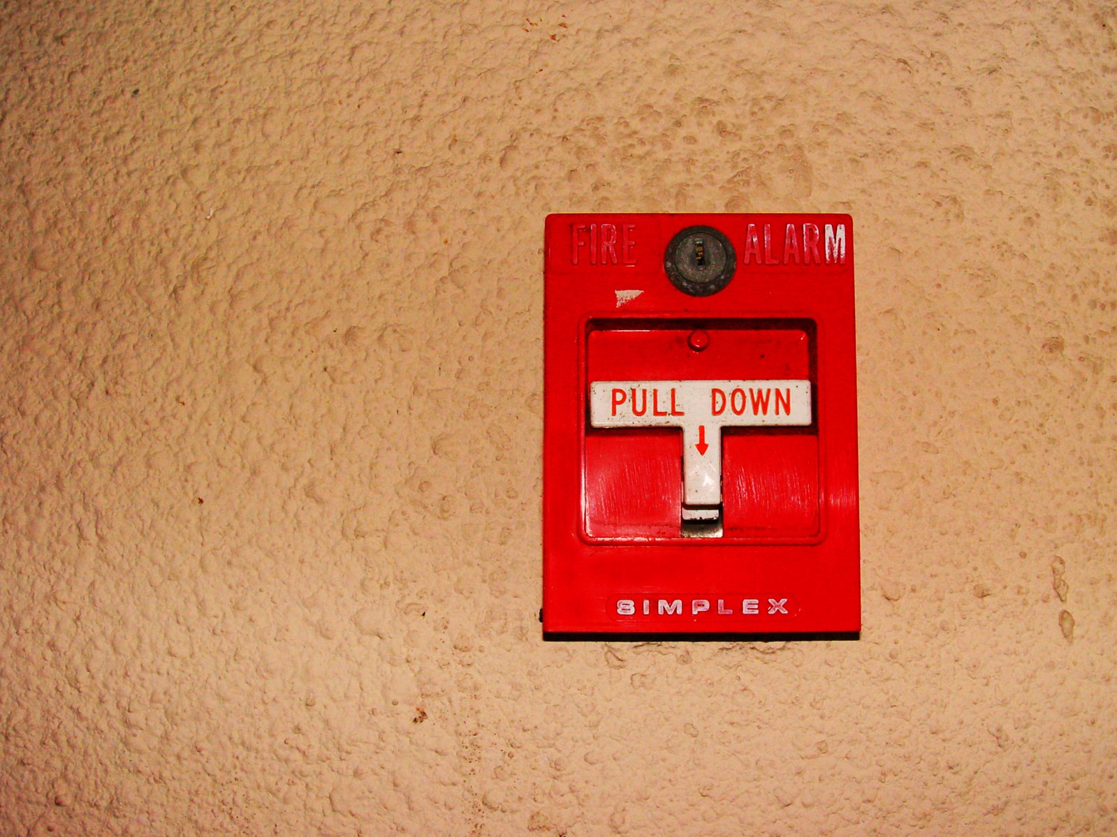 an old fashioned red switch that has a white h on