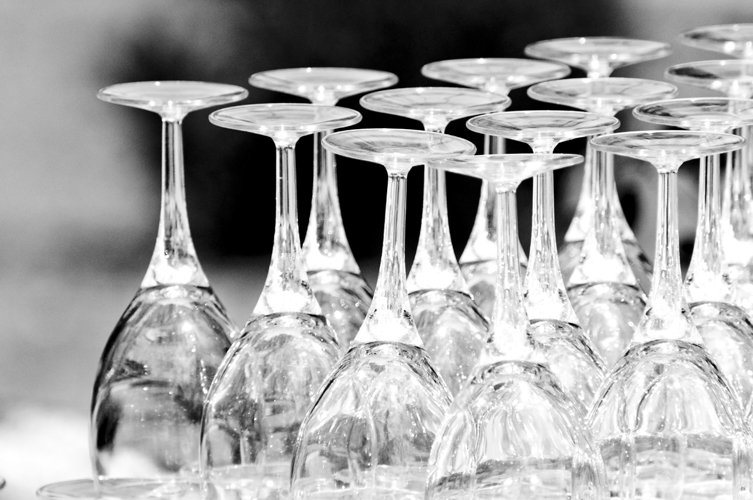 a row of wine goblets sitting on a table