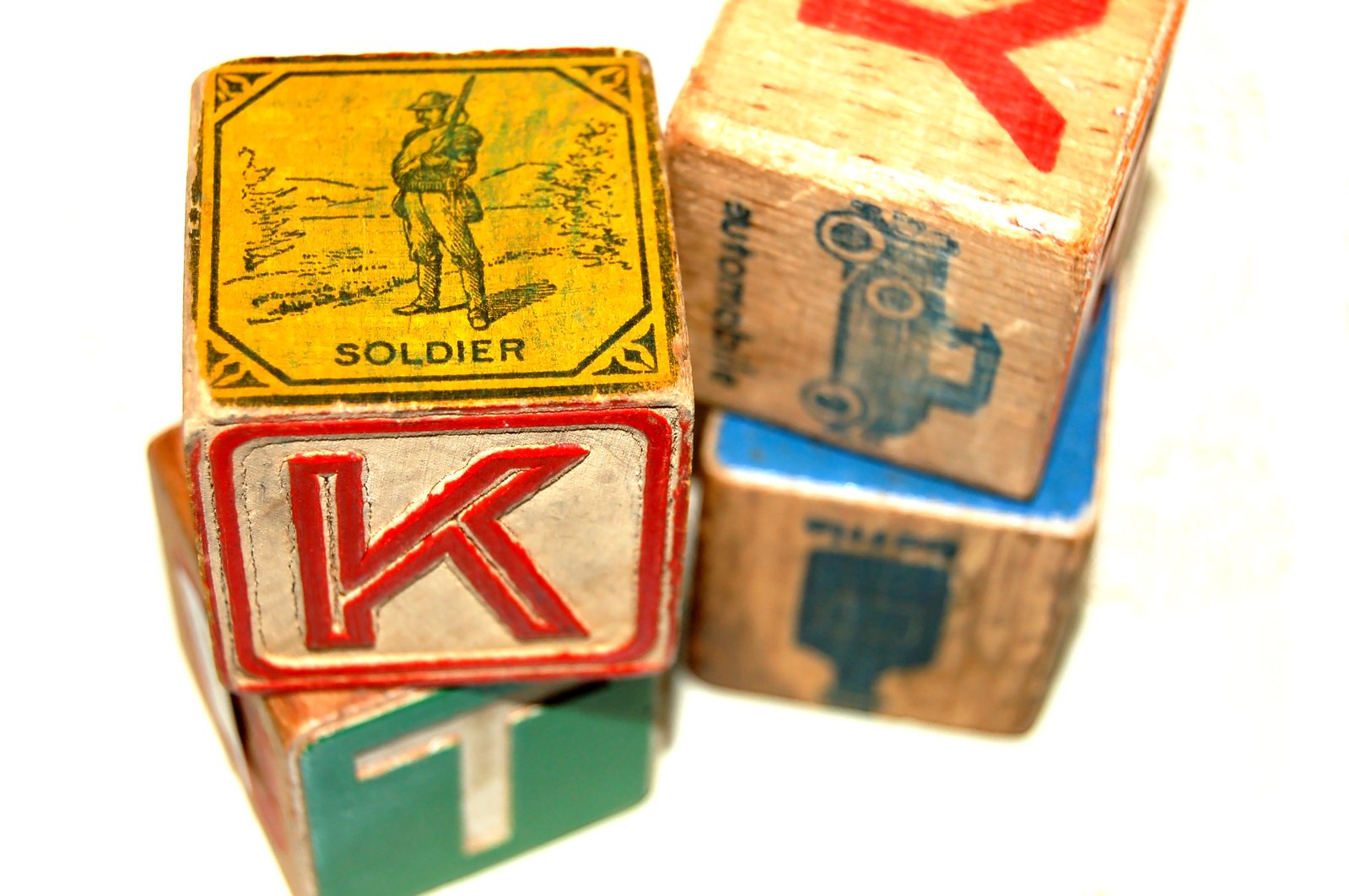 three wooden blocks with various items carved onto them