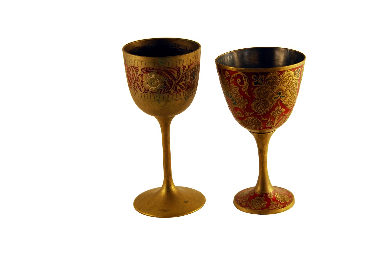 two golden goblets are set on a white background