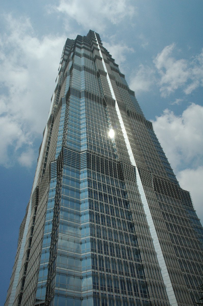 view of the tall building's corner from below