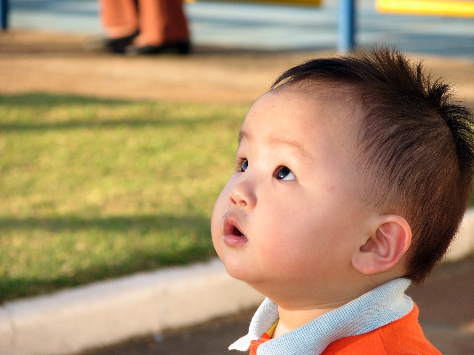 a small child with short hair wearing a jacket