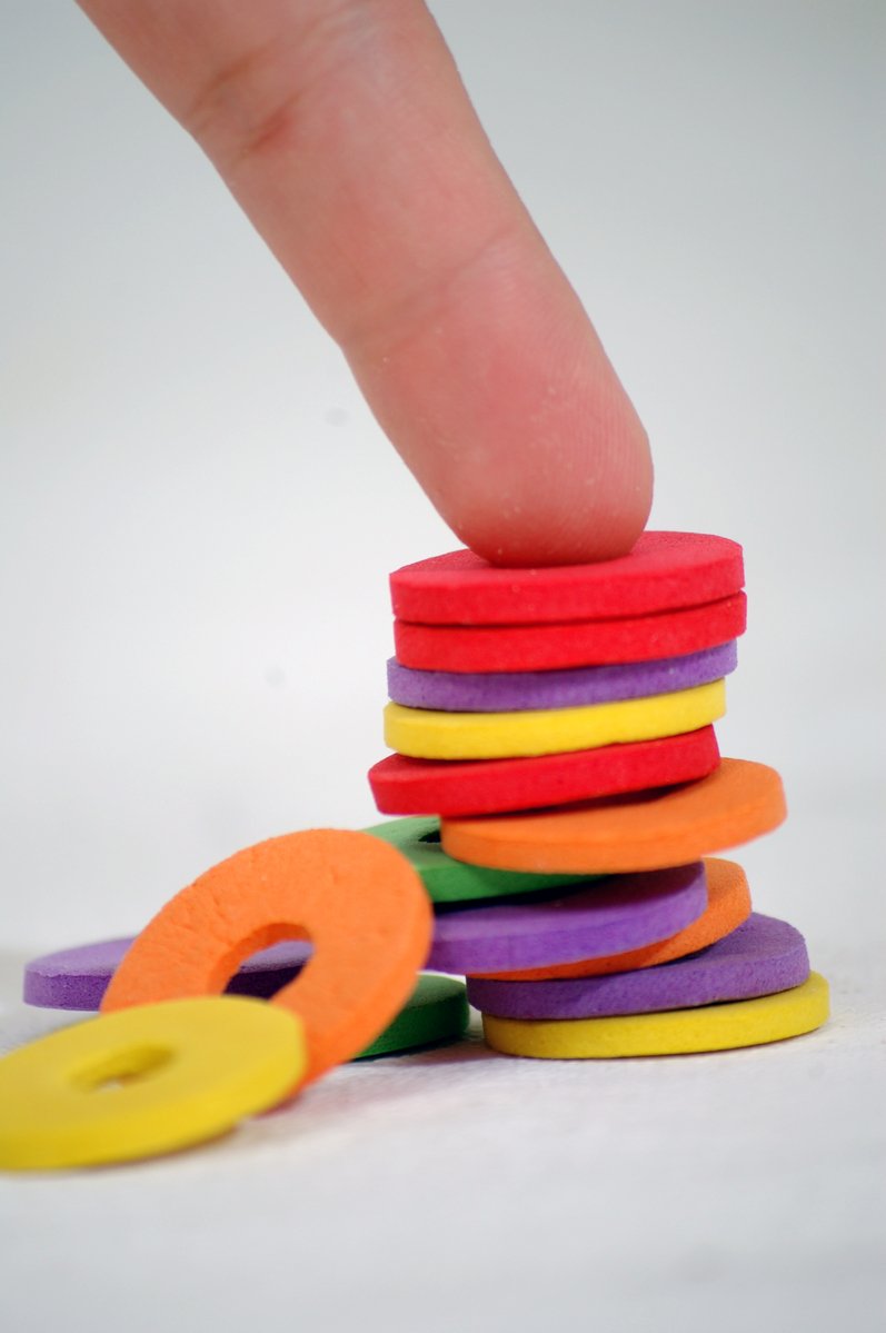 a stack of plastic objects made from colored discs
