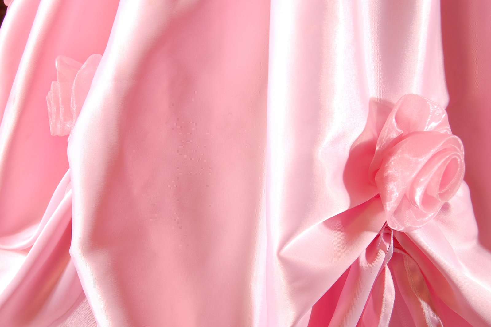 closeup of pink satin material with flower