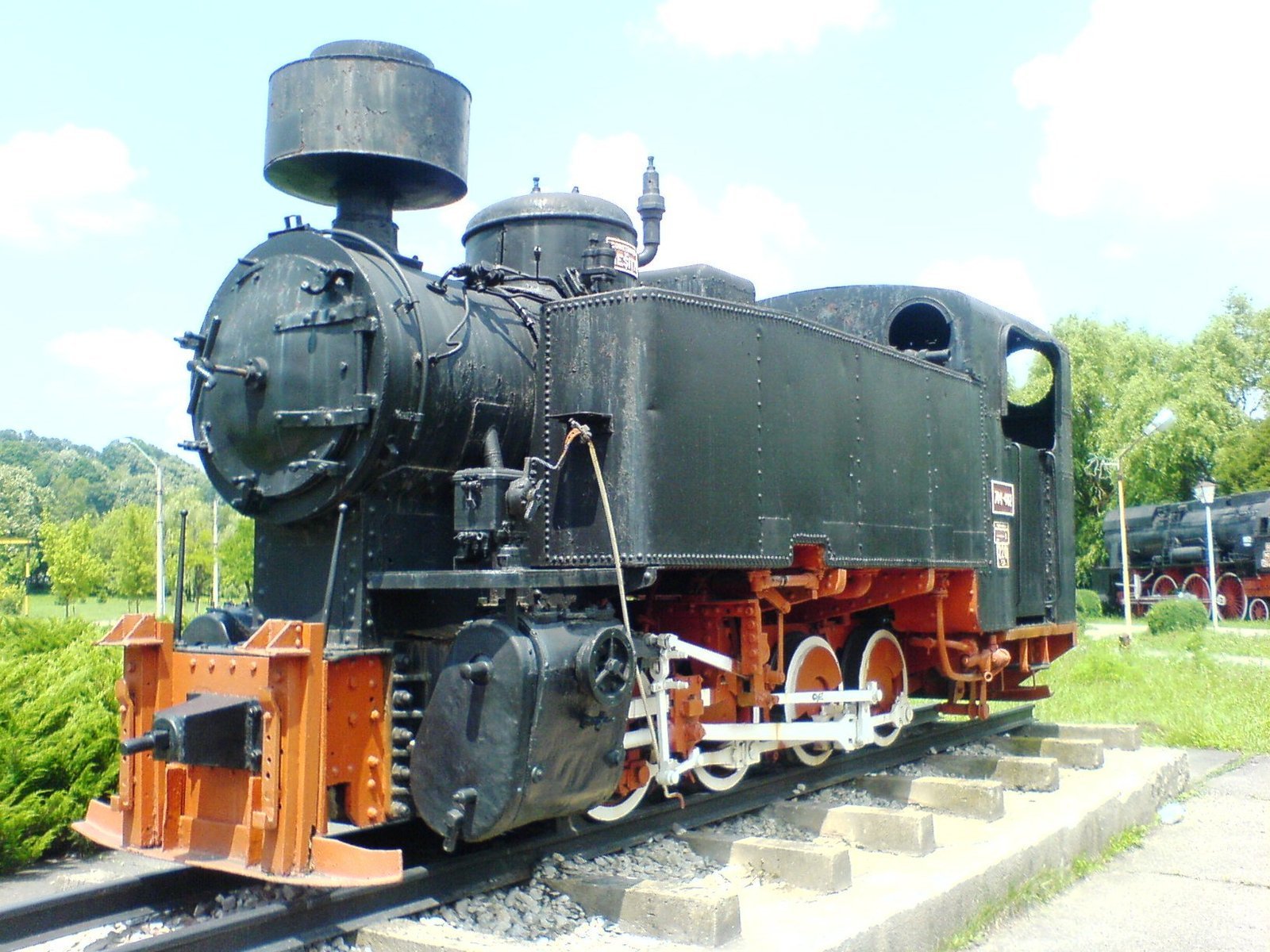 an old train engine is parked on some tracks