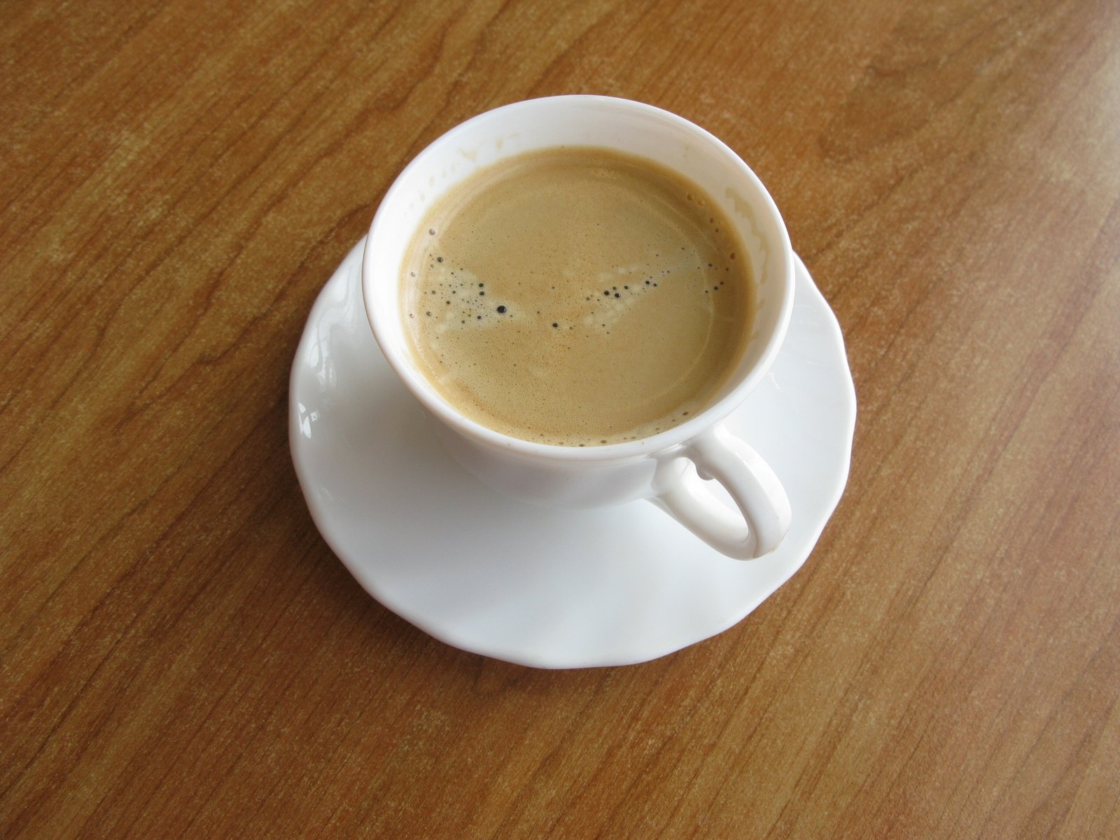 a coffee cup sitting on top of a white saucer