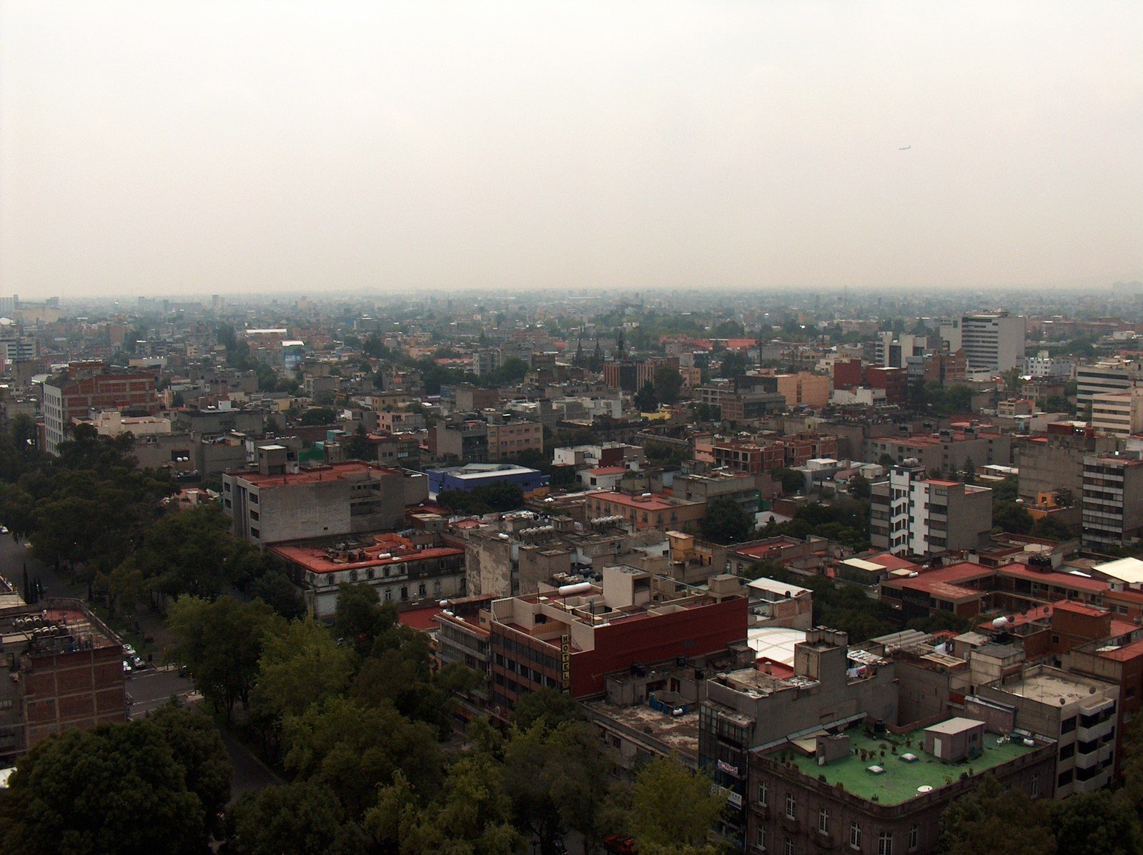 a very tall city with some buildings and a clock on top