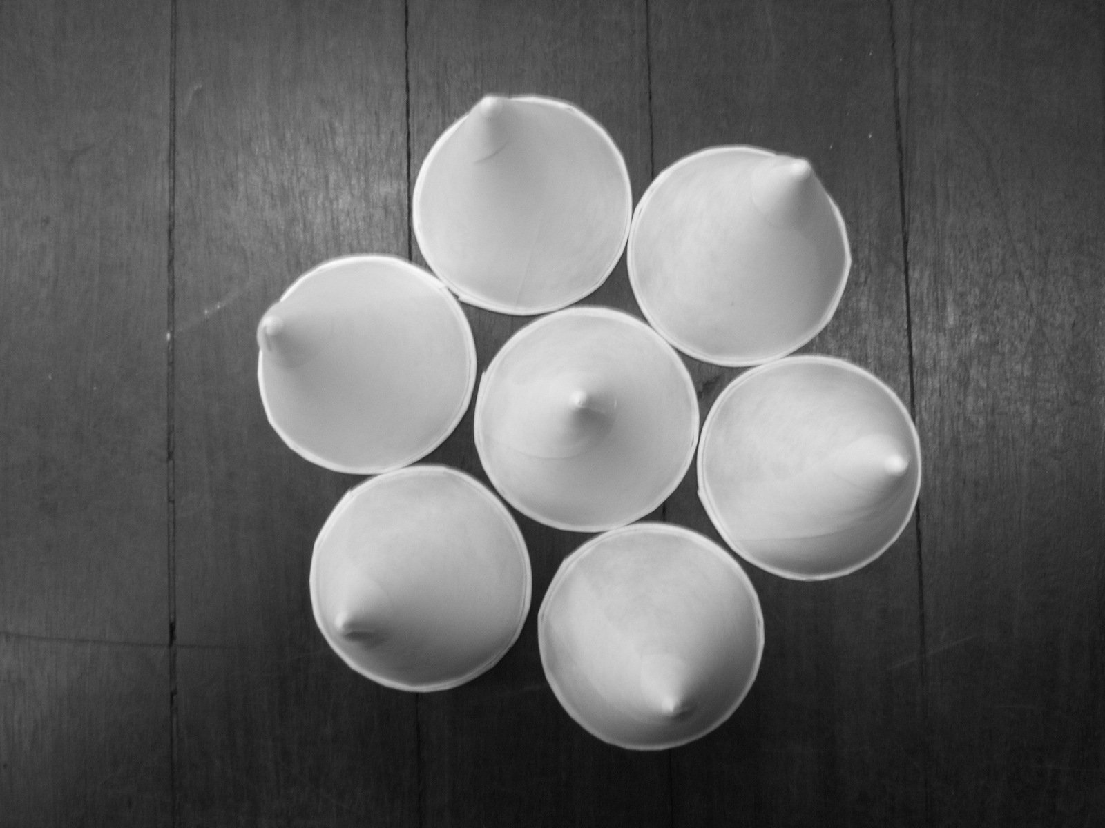 six empty bowls on a wooden surface